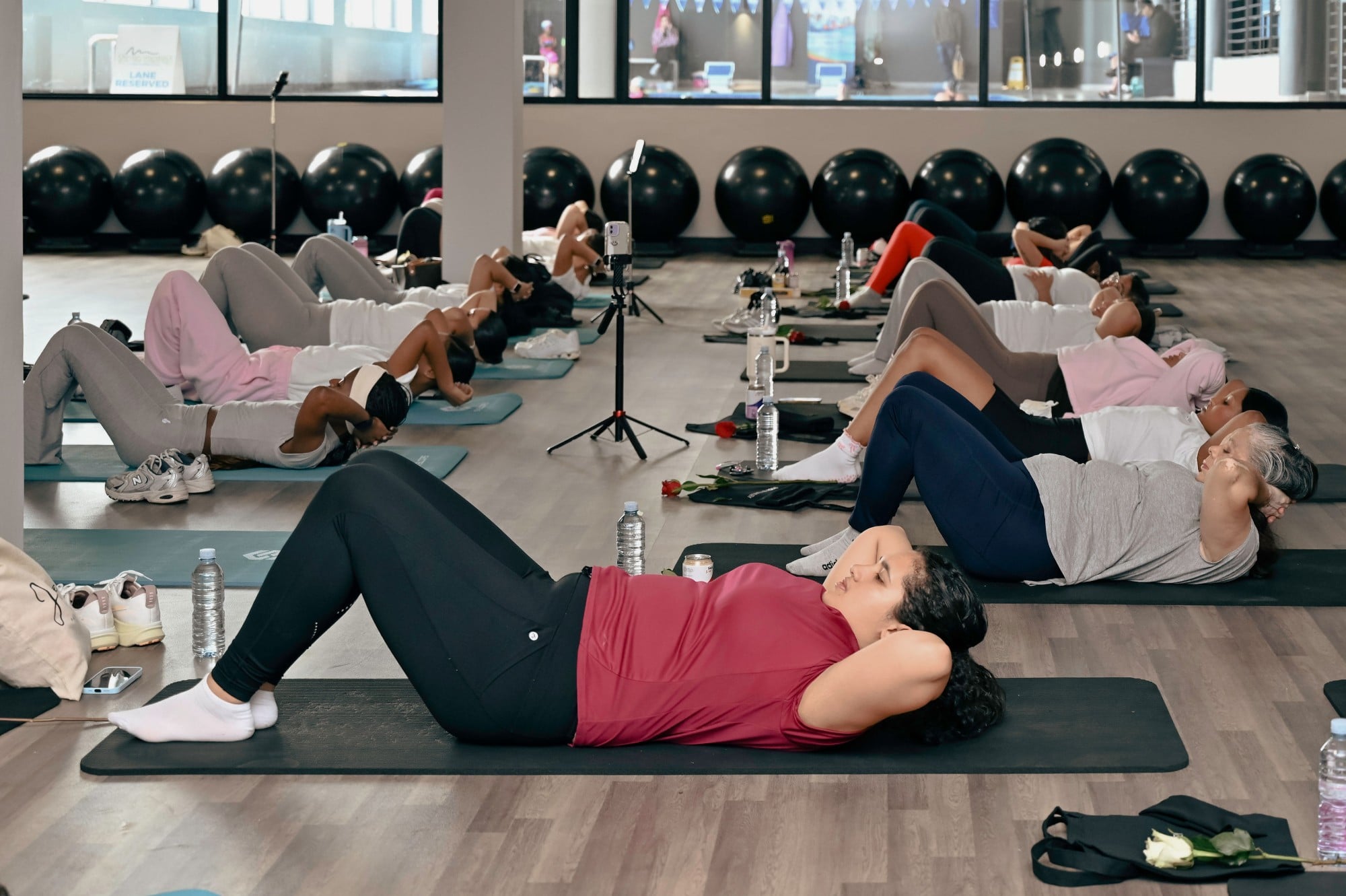 Women doing core work together on their mats