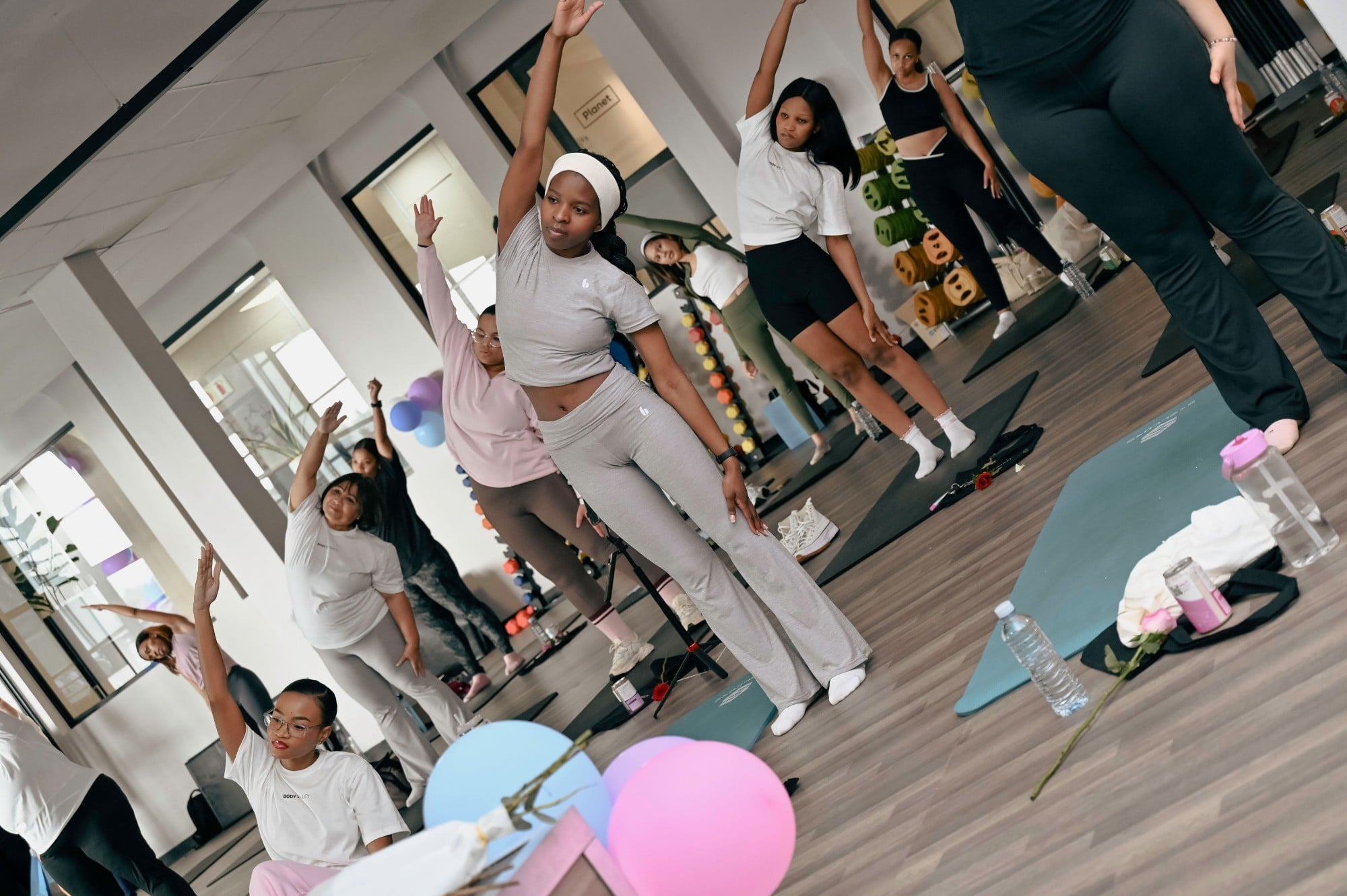 Women reaching high in a side stretch