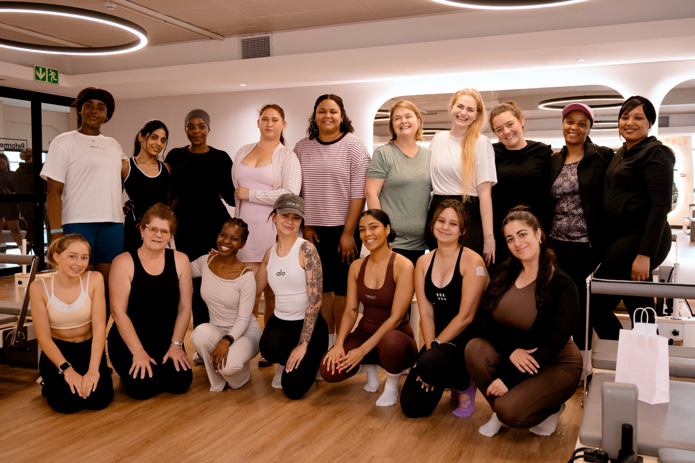 A group picture of Women in a reformer Pilates studio